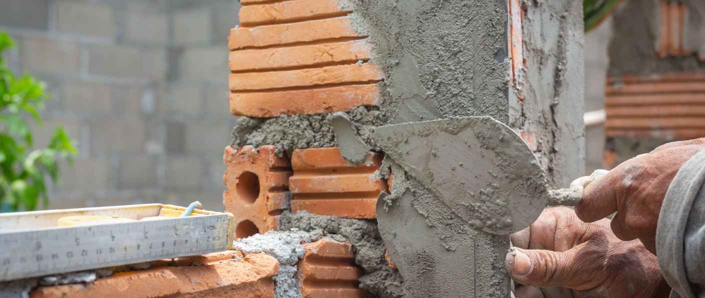 AAC block adhesive application during modern lightweight block wall construction