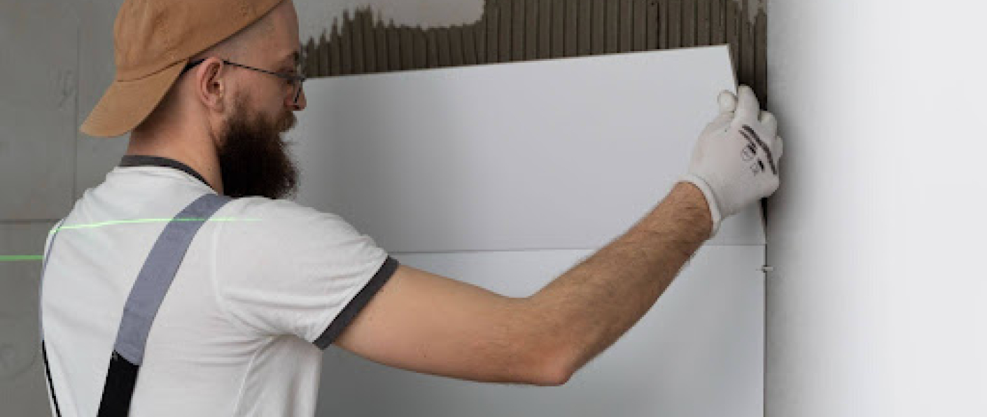 Professional installing ceramic floor tiles using VURA premium tile adhesive for strong and durable bonding.