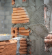AAC block adhesive application during modern lightweight block wall construction