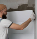 Professional installing ceramic floor tiles using VURA premium tile adhesive for strong and durable bonding.